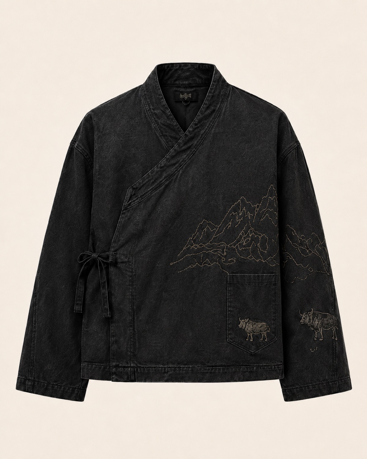 Achala daura jacket — front: gold Himalayan ridge embroidered across the chest, yaks on the pocket and sleeve